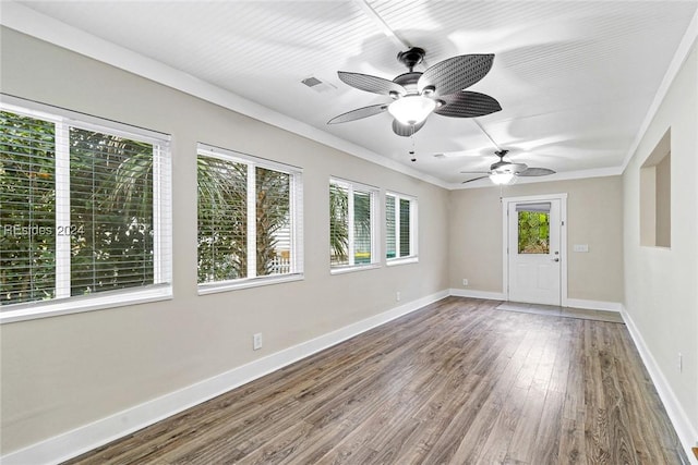 unfurnished room with hardwood / wood-style flooring, a wealth of natural light, ornamental molding, and ceiling fan