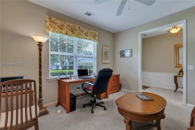 carpeted office featuring ceiling fan