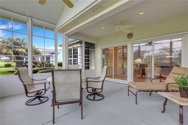 sunroom / solarium featuring ceiling fan