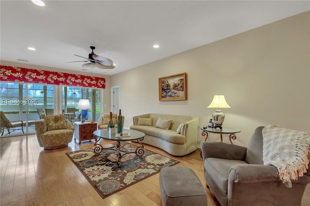 living room with ceiling fan and light hardwood / wood-style floors