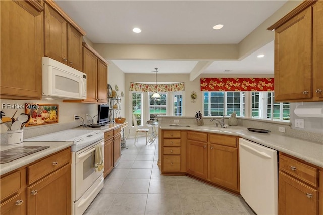 kitchen with sink, white appliances, beam ceiling, decorative light fixtures, and kitchen peninsula