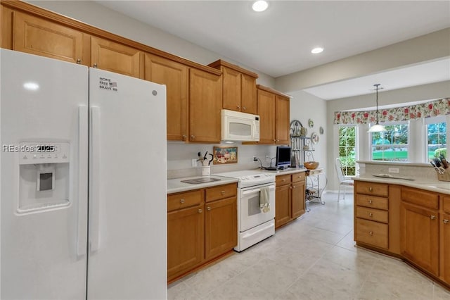 kitchen featuring pendant lighting and white appliances