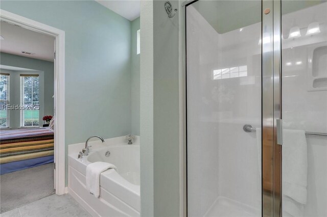 bathroom with tile patterned floors and independent shower and bath