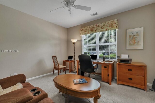 carpeted office featuring ceiling fan