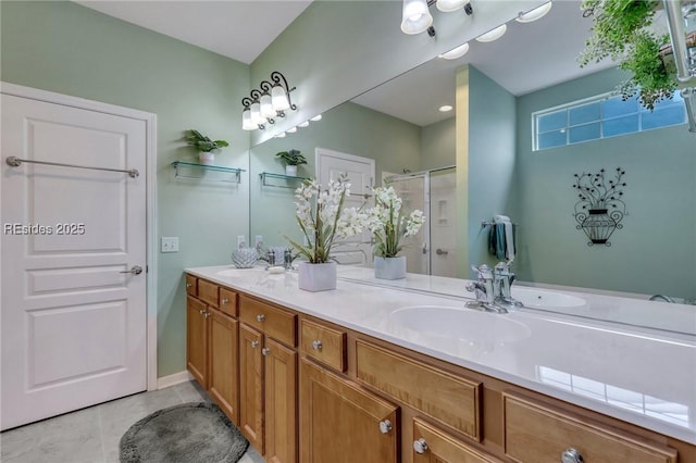 bathroom featuring tile patterned floors, a shower with shower door, and vanity