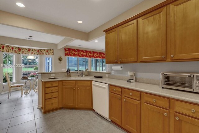 kitchen with white dishwasher, sink, a wealth of natural light, and kitchen peninsula