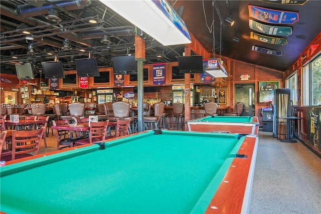 rec room with bar, pool table, and vaulted ceiling