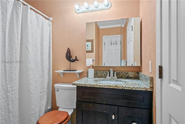 bathroom featuring crown molding, vanity, and toilet