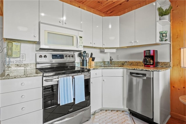 kitchen featuring sink, wood ceiling, white cabinetry, stainless steel appliances, and light stone counters