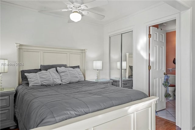 bedroom featuring crown molding, hardwood / wood-style floors, ceiling fan, and a closet