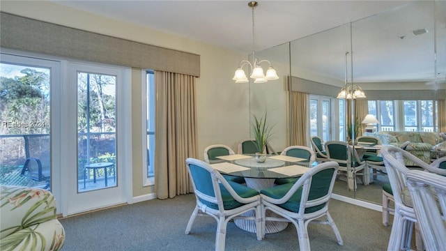 carpeted dining space featuring a notable chandelier and a healthy amount of sunlight