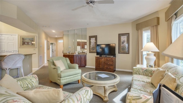 living room featuring carpet floors and ceiling fan