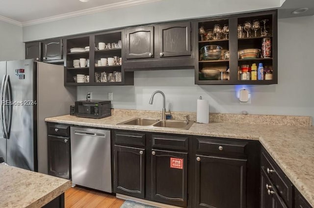 kitchen featuring sink, ornamental molding, dark brown cabinetry, stainless steel appliances, and light hardwood / wood-style flooring