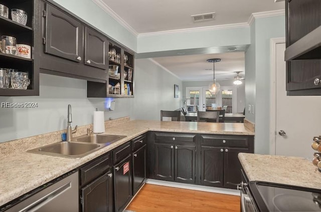 kitchen featuring pendant lighting, sink, light hardwood / wood-style flooring, and ornamental molding