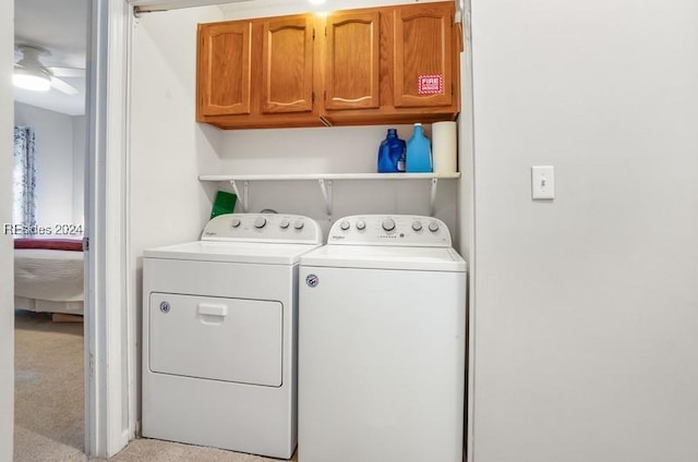 laundry area featuring cabinets, ceiling fan, light carpet, and independent washer and dryer