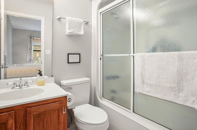 full bathroom with vanity, shower / bath combination with glass door, and toilet