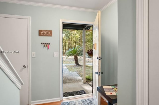 doorway with crown molding and hardwood / wood-style floors