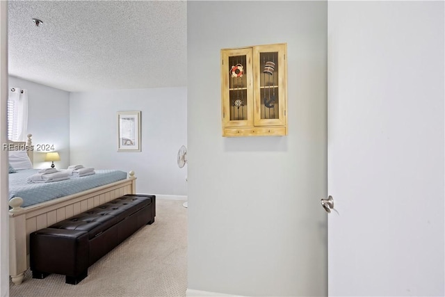 carpeted bedroom with a textured ceiling