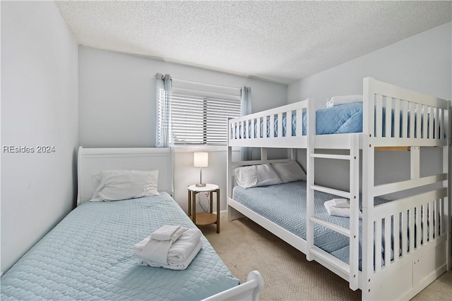 carpeted bedroom featuring a textured ceiling