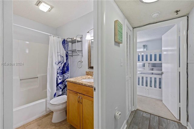 full bathroom with vanity, shower / tub combo, hardwood / wood-style flooring, and toilet