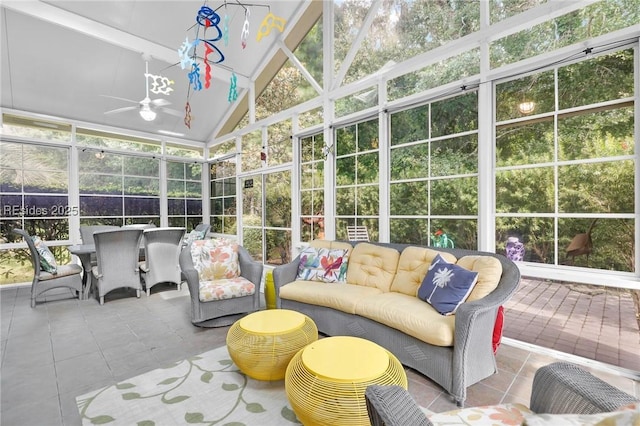 sunroom / solarium featuring ceiling fan, vaulted ceiling, and a wealth of natural light