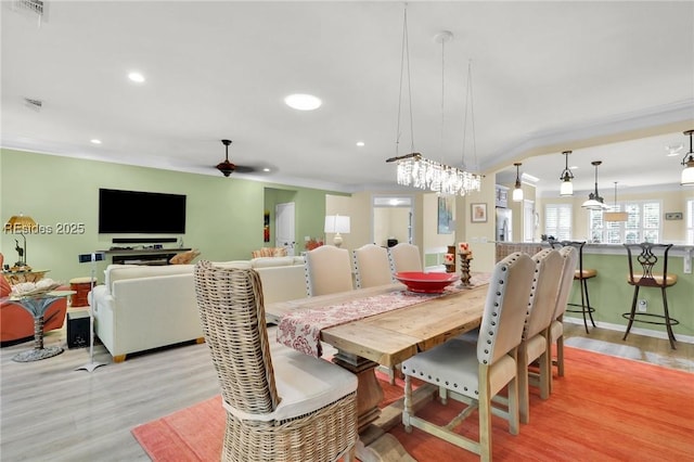 dining space featuring ceiling fan and light wood-type flooring