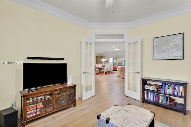 sitting room featuring hardwood / wood-style floors, crown molding, and french doors