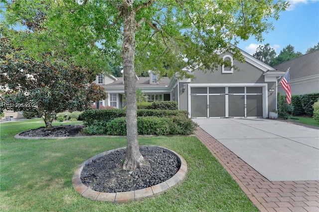 view of front of property featuring a garage and a front yard