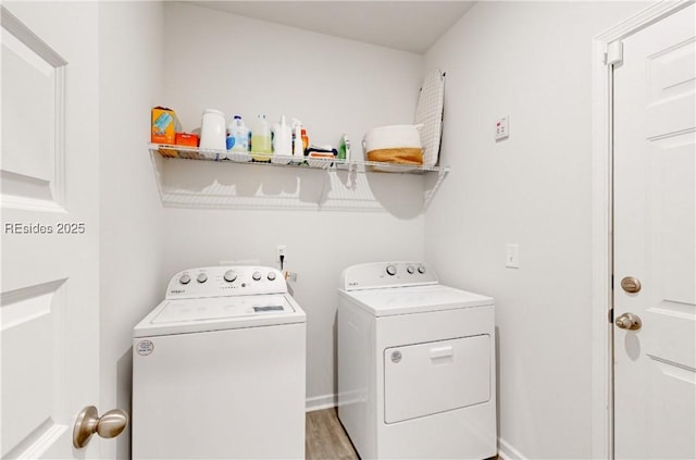 washroom with separate washer and dryer and light hardwood / wood-style flooring