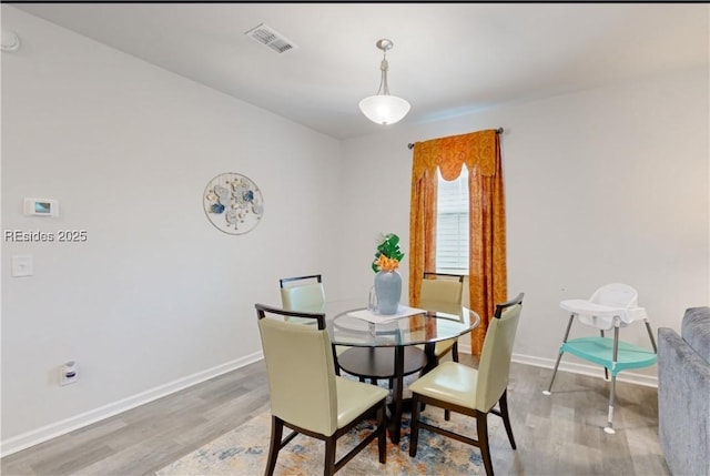 dining area with wood-type flooring