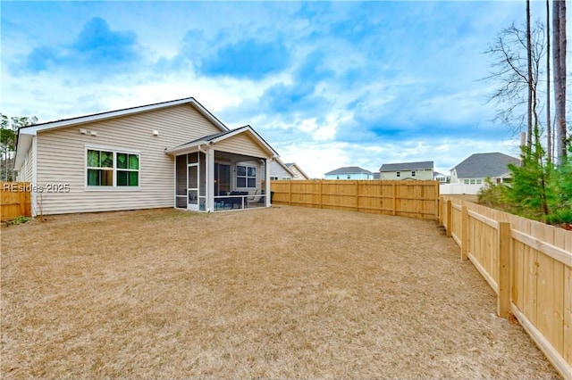 back of property with a sunroom