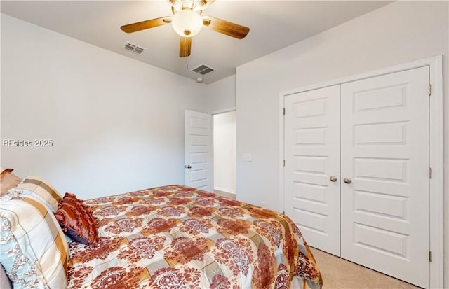 bedroom featuring light carpet, ceiling fan, and a closet