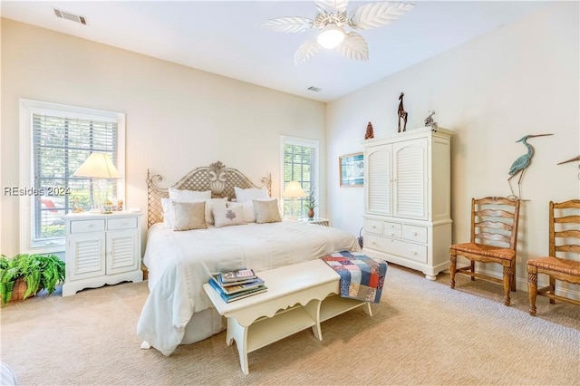 bedroom featuring light carpet and ceiling fan