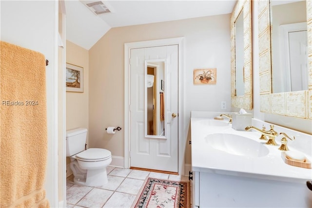 bathroom featuring vanity, toilet, tile patterned flooring, and vaulted ceiling