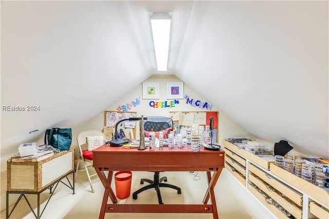 office with carpet floors and vaulted ceiling