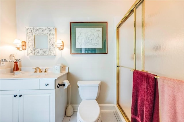 bathroom featuring vanity, an enclosed shower, and toilet