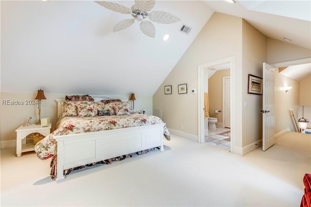 bedroom with vaulted ceiling, ceiling fan, ensuite bathroom, and light colored carpet