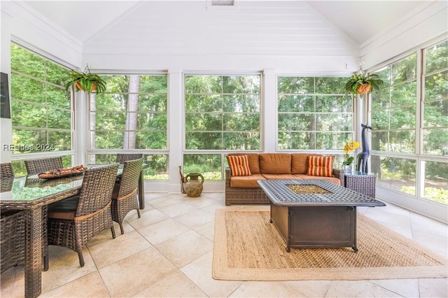 sunroom featuring vaulted ceiling