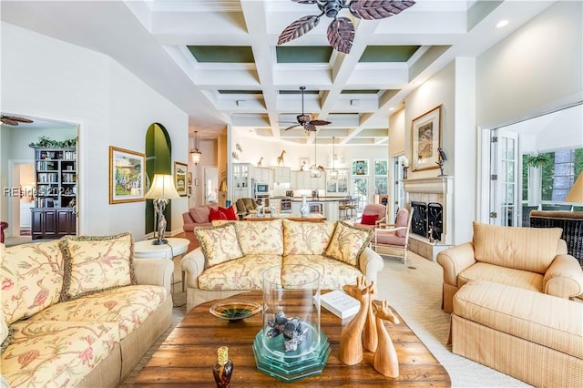 living room with coffered ceiling, beamed ceiling, and ceiling fan