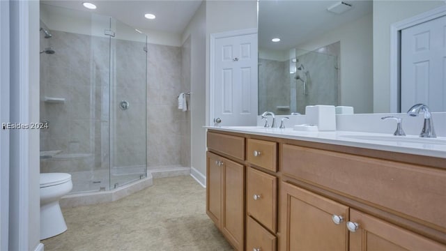 bathroom featuring walk in shower, vanity, and toilet