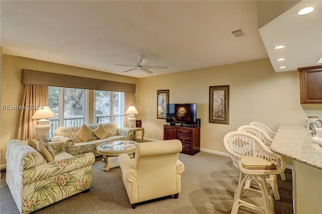 living room featuring light carpet and ceiling fan