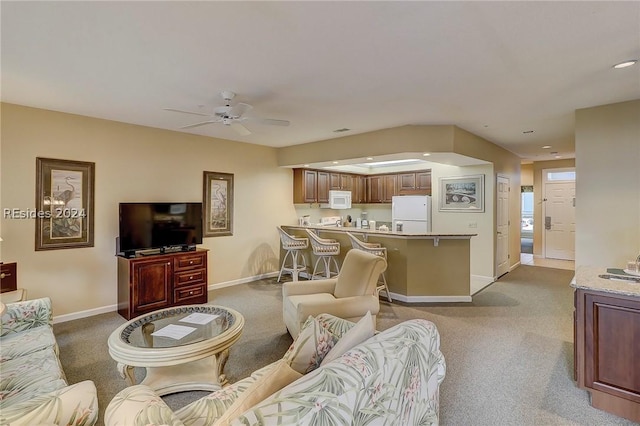 living room with ceiling fan and carpet flooring