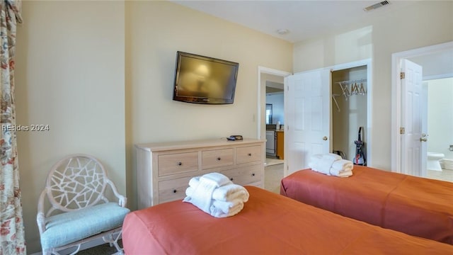 bedroom featuring ensuite bath and a closet