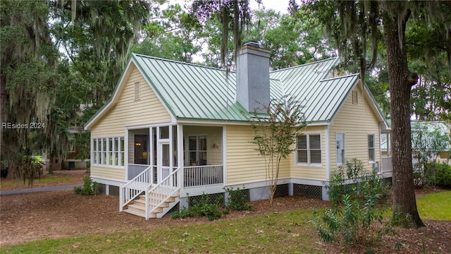 rear view of house with a sunroom