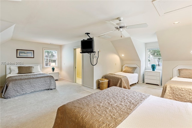 carpeted bedroom with vaulted ceiling and ceiling fan