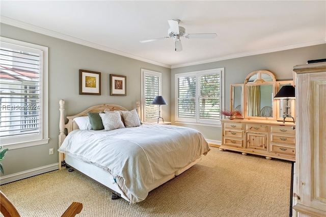 carpeted bedroom with crown molding and ceiling fan