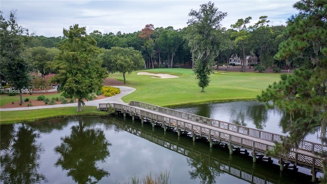 view of community with a lawn and a water view