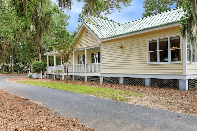 view of property exterior featuring covered porch