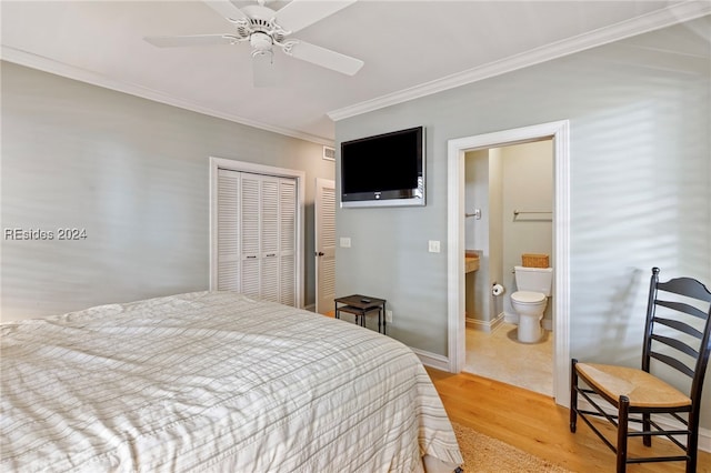 bedroom with a closet, ceiling fan, crown molding, ensuite bath, and light hardwood / wood-style flooring