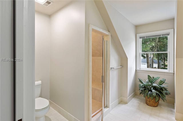 bathroom featuring toilet and an enclosed shower